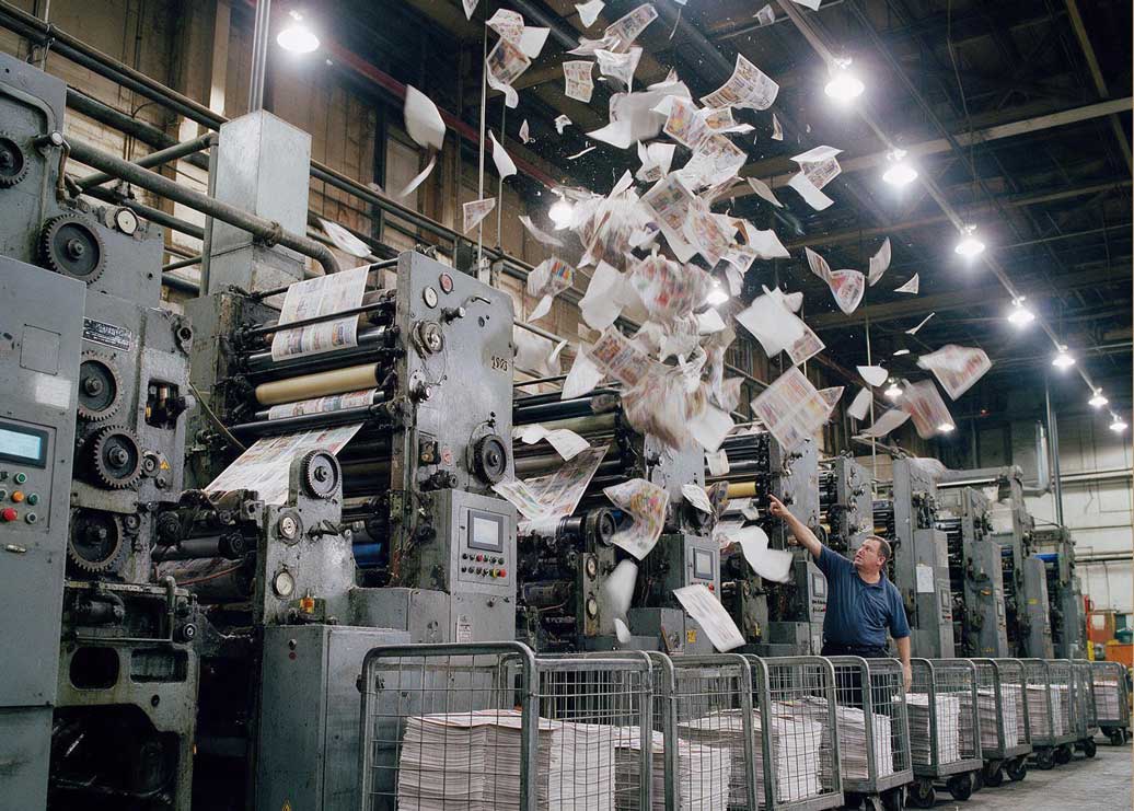A newspaper press spewing out paper 